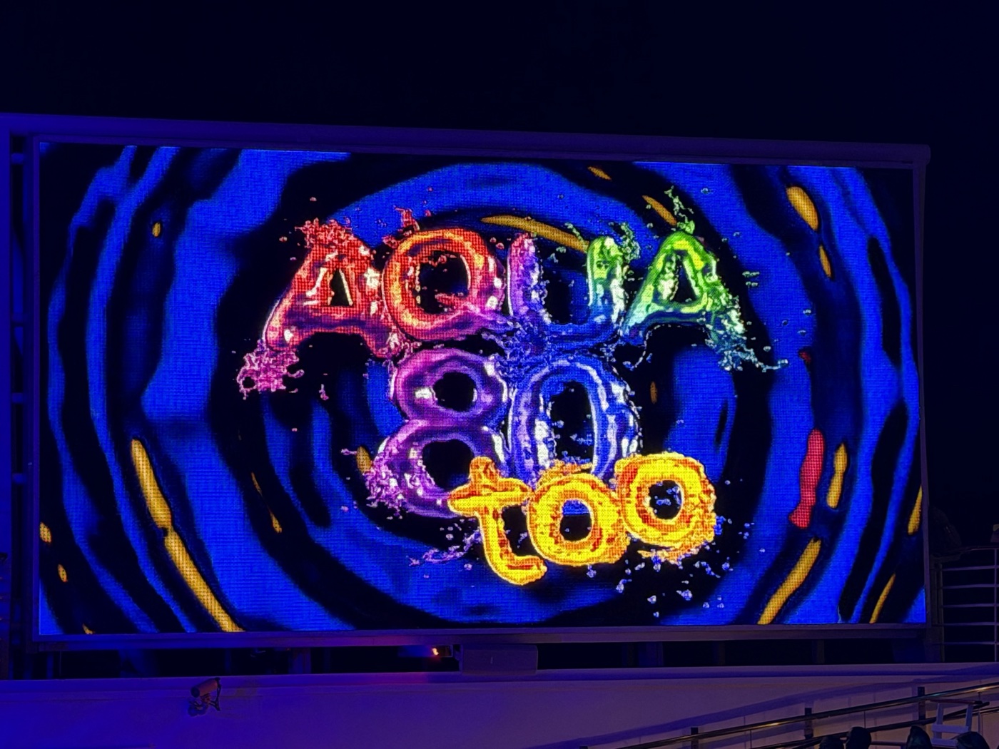 The Aqua80 Too AquaTheater show title lit up on the big LED screen
