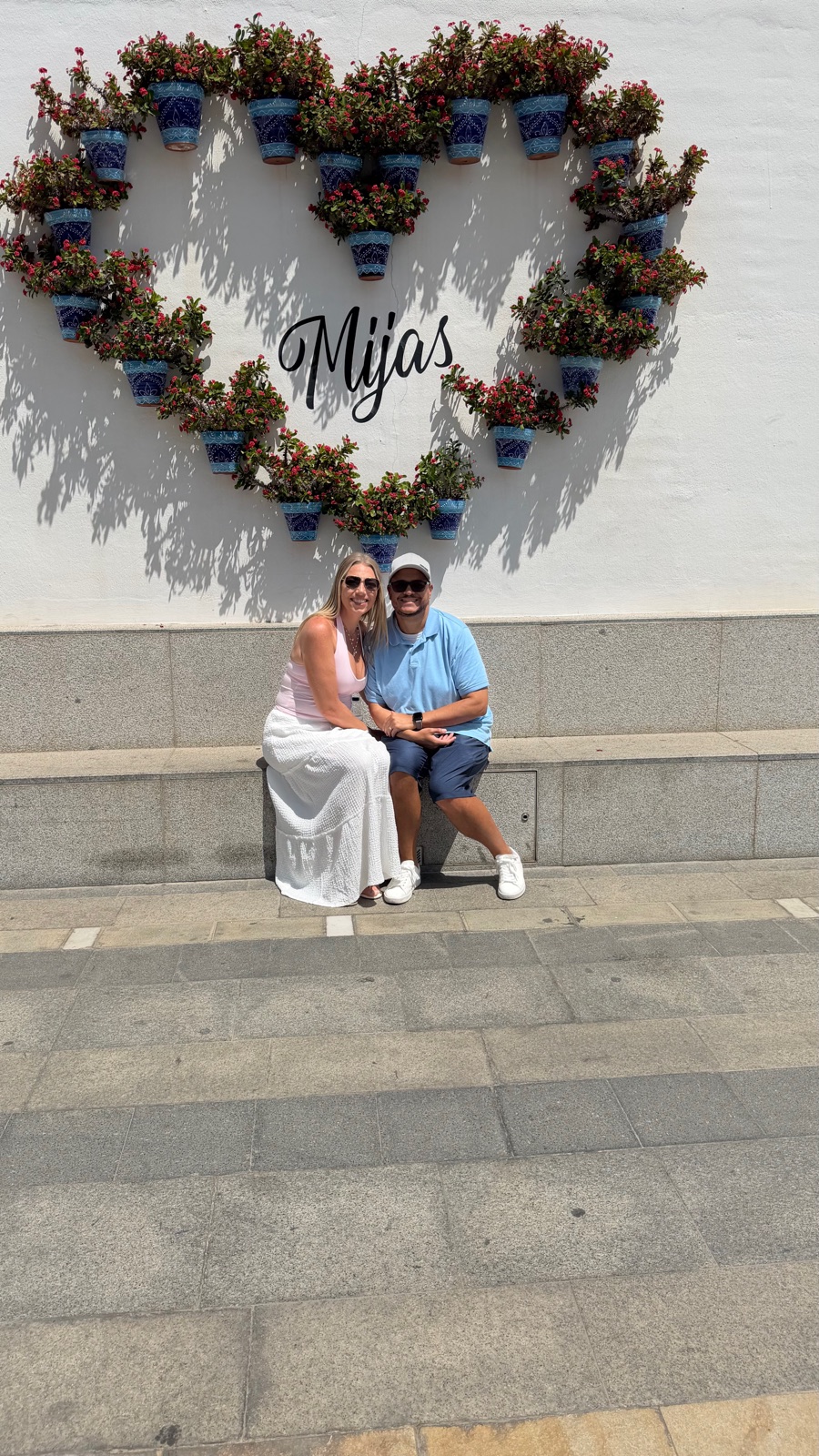 Miguel and Ashley at the heart-shaped flower pot wall in Mijas