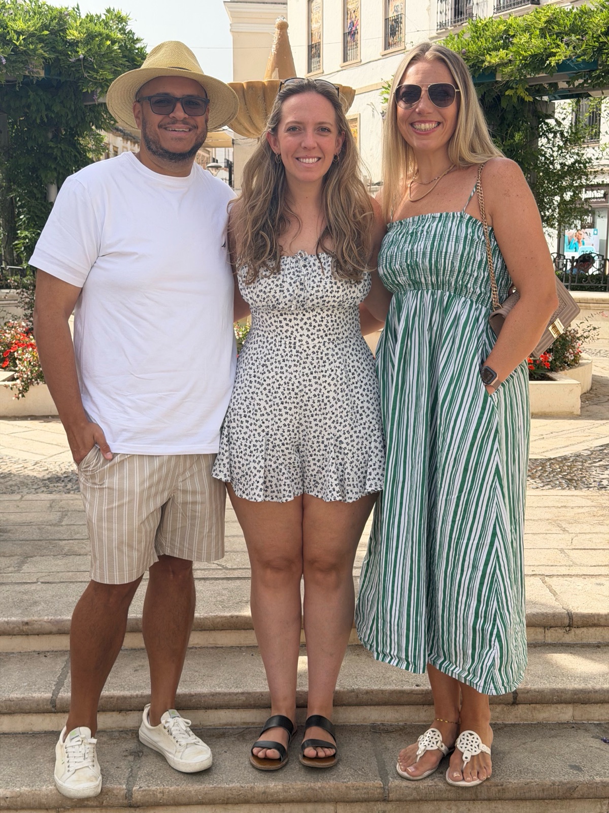 Miguel, Jordan and Ashley on the steps by a fountain in Ronda