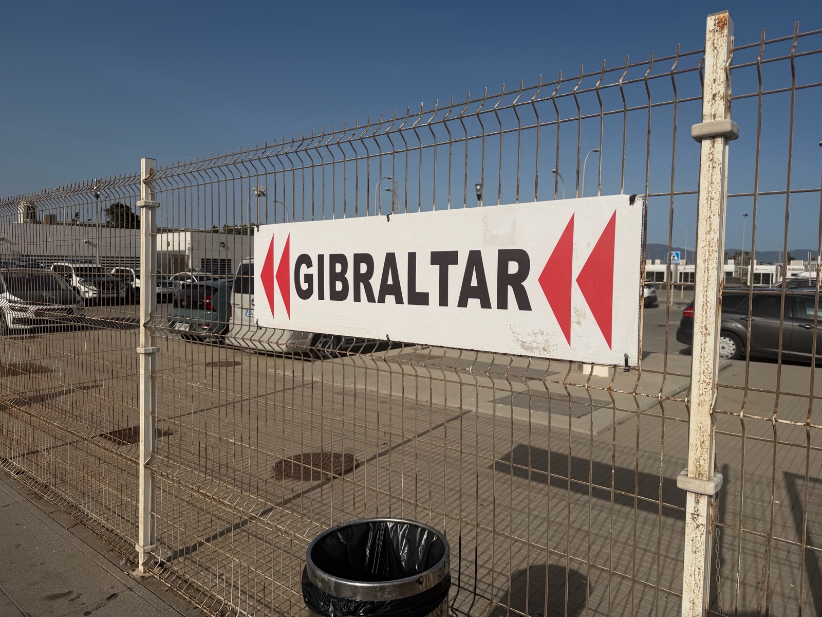 The red arrow Gibraltar sign on a fence by the customs building