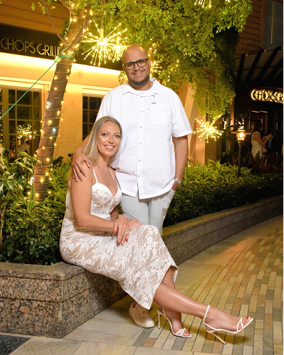 Miguel and Ashley dressed in white outside Chops Grille on Symphony of the Seas, White Night
