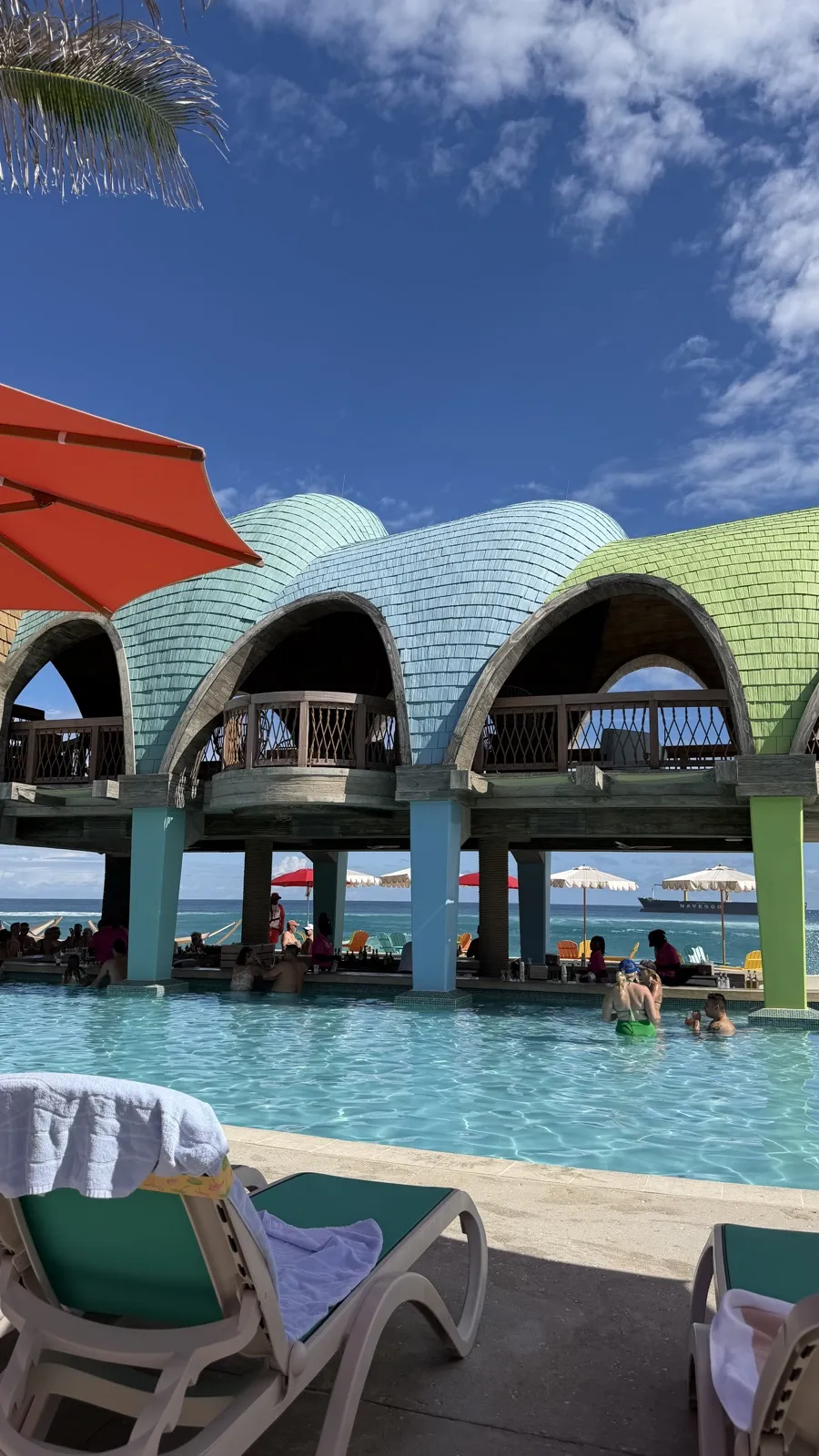 The pool and arched, shingle-roofed cabana buildings at Royal Beach Club Paradise Island