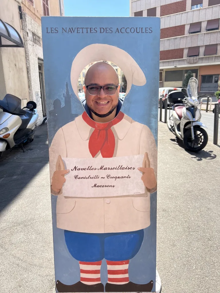 Miguel in a navette baker face cutout outside a bakery in Marseille